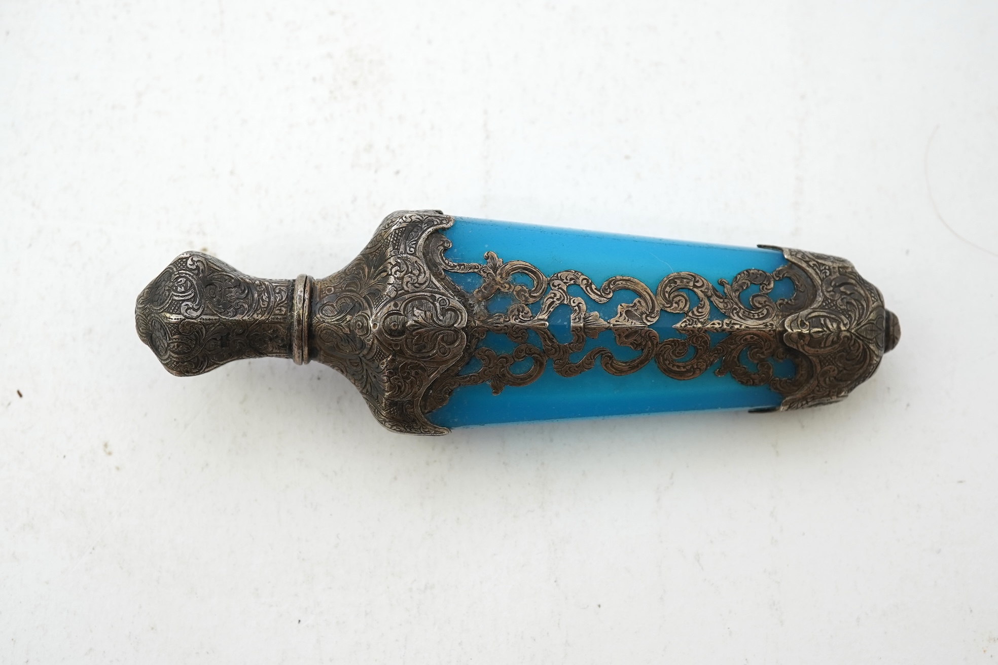 A late 19th century French white metal mounted and overlaid blue opaline glass scent flask